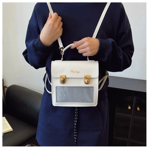 Close-up of white PU leather ita bag featuring gold clasp and mesh display window
