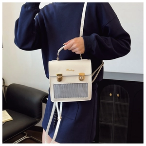 White Japanese ita bag with mesh pocket and gold buckles shown on a navy sweatshirt