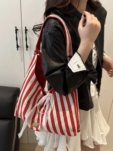 Red and white striped canvas tote bag with a white lace bow and handmade leather tag