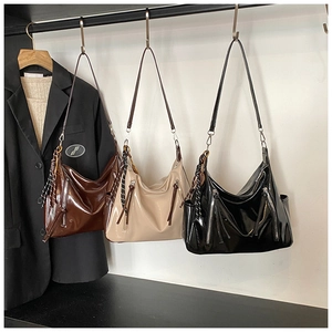 Modern Hobo bags in dark brown, cream, and black showing glossy patent leather details