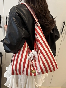 Red and white striped canvas tote bag with lace bow and handmade metal emblem detail