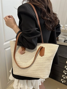 Straw tote bag with brown leather straps and pink butterfly embroidery for beach vacations