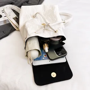 Top view of open bucket backpack showing large capacity for tablet, umbrella and phone
