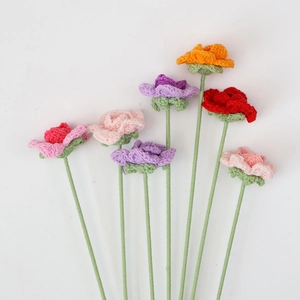 Detailed view of colorful hand-knitted crochet roses for gift bouquets and home decor