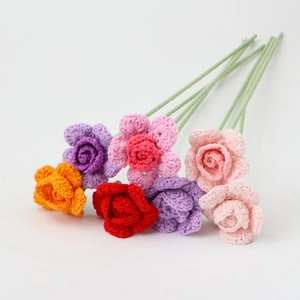 Detailed knit texture of six colorful handmade crochet roses for home decoration
