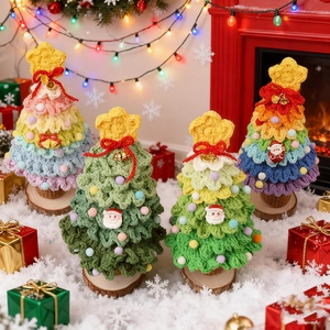 Handcrafted crochet Christmas trees with festive ornaments on a wooden base decor
