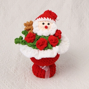 Handmade crochet Christmas bouquet with Santa Claus, red roses and festive gift wrapping