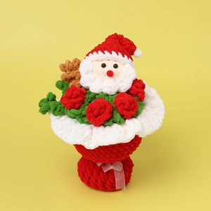 Close-up of handmade crochet Christmas bouquet with Santa Claus and red knitted roses