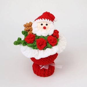Detail of handmade crochet Santa Claus and red rose bouquet with white ribbon