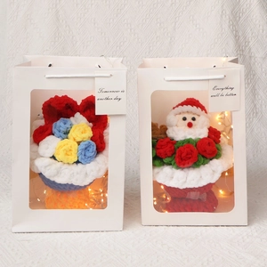 Handmade crochet flower bouquet with LED lights in a white gift bag for Christmas