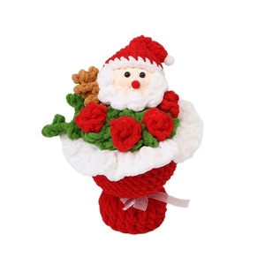 Handmade crochet Christmas bouquet featuring Santa Claus and red knitted roses with ribbons
