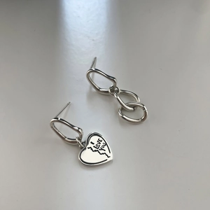 Detailed view of asymmetric S925 silver earrings with chain links and engraved heart charm