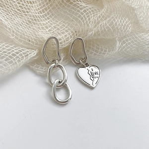 Asymmetric s925 silver heart earrings with I LOVE YOU engraving on white background