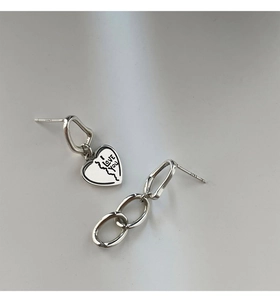 Macro detail of S925 silver asymmetric heart and chain earrings with I Love You engraving