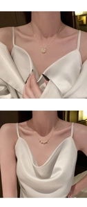 Detailed view of foldable magnetic necklace showing clover and heart shapes in gold