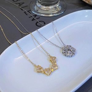 Dual-wear foldable heart necklace transforms into a sparkling clover pendant