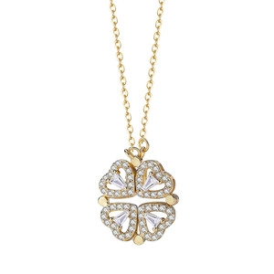 Folding gold clover necklace with heart petals and sparkling crystals on white backdrop