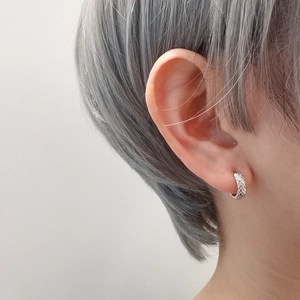 Elegant S925 silver hollow grid hoop earring worn on ear with minimalist style