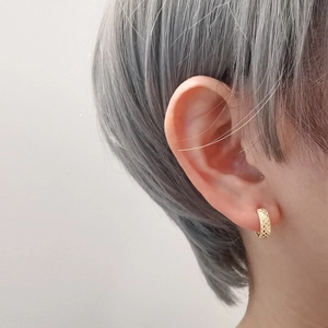 Golden S925 silver hoop earrings with hollow grid pattern worn by a female model