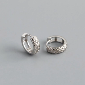 Detail of S925 sterling silver stamp and quilted texture on the circular earrings