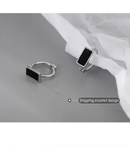 Macro detail of S925 silver rectangular earrings with black drip glaze finish
