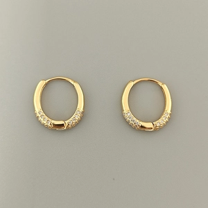 Close-up of gold-plated 925 sterling silver hoop earrings with micro-set cubic zirconia