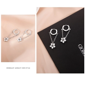 Detail of S925 sterling silver flower chain earrings with sparkling white cubic zirconia