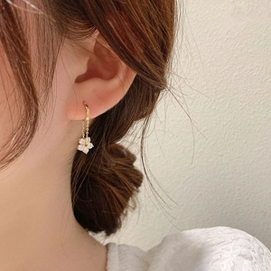 Elegant gold S925 silver flower chain earrings with sparkling zircon crystals on model