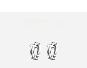 Macro shot of silver dual-layer hoop earrings with high-polish finish and hollow design