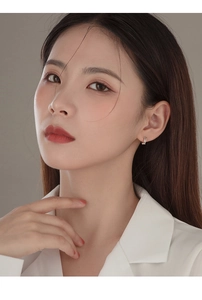 Close-up of S925 sterling silver geometric double-layer hoop earrings worn by a model