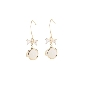 Elegant gold bow earrings with cat eye stone pendants on a clean white background