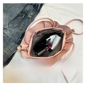 Top view of pink pleated tote bag interior showing capacity for cosmetics and skincare