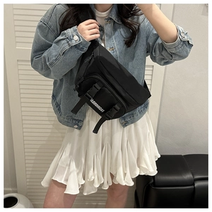 Detail of black utility chest bag featuring quick-release buckle and adjustable strap