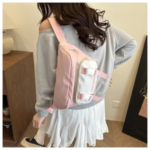 Detail of pink and white patchwork crossbody bag showing side FASHIONBAG text and buckle