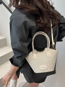 Chic beige woven bucket bag with top handles and adjustable shoulder strap for women