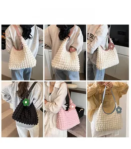 Detail of multi-color bubble textured tote bags with floral charms and faux leather straps