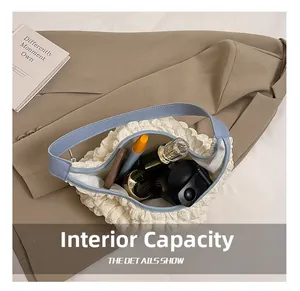 Spacious interior of white bubble textured tote bag holding daily makeup and phone