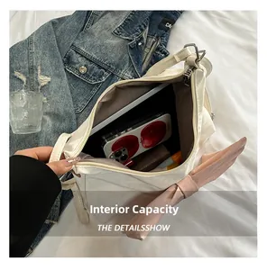 Interior view showing the large capacity of the cream shoulder bag with pink bow