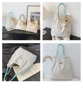 Detailed close-up of floral canvas tote bag showing drawstring closure and lion plush charm