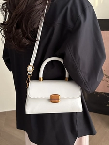 Elegant white oil wax leather crossbody bag with vintage bronze buckle and top handle