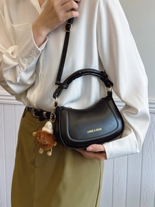 Chic black crescent saddle bag with gold logo and cute bear pendant for women