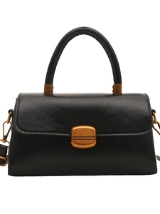 Classic black oil wax leather crossbody handbag with vintage gold buckle on white background