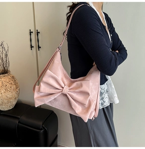 Detail of the large sweet pink bow design on the suede shoulder tote bag for women