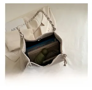 Top view of woven tote bag interior showing capacity with tablet and folded umbrella