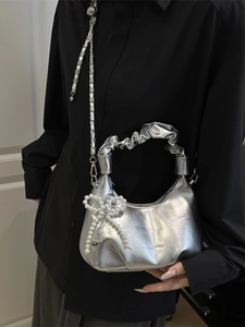 Metallic silver hobo bag with pleated handle, pearl bow charm and chain strap