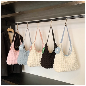 Close-up of spring tote bags with pop-bubble texture in five colors and flower charms