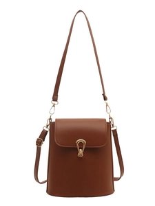 Minimalist tan bucket bag with gold U-shaped buckle and adjustable shoulder strap