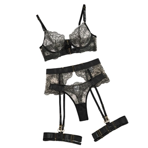 Sexy black floral lace lingerie set with metal buckles and garters on white background