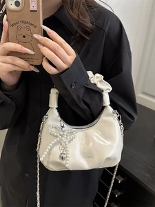 Silver glossy crescent bag with pearl bow, heart charm and silver chain strap