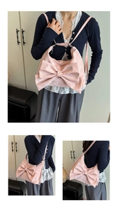 Pink tote bag with large bow detail shown in front and side views on model